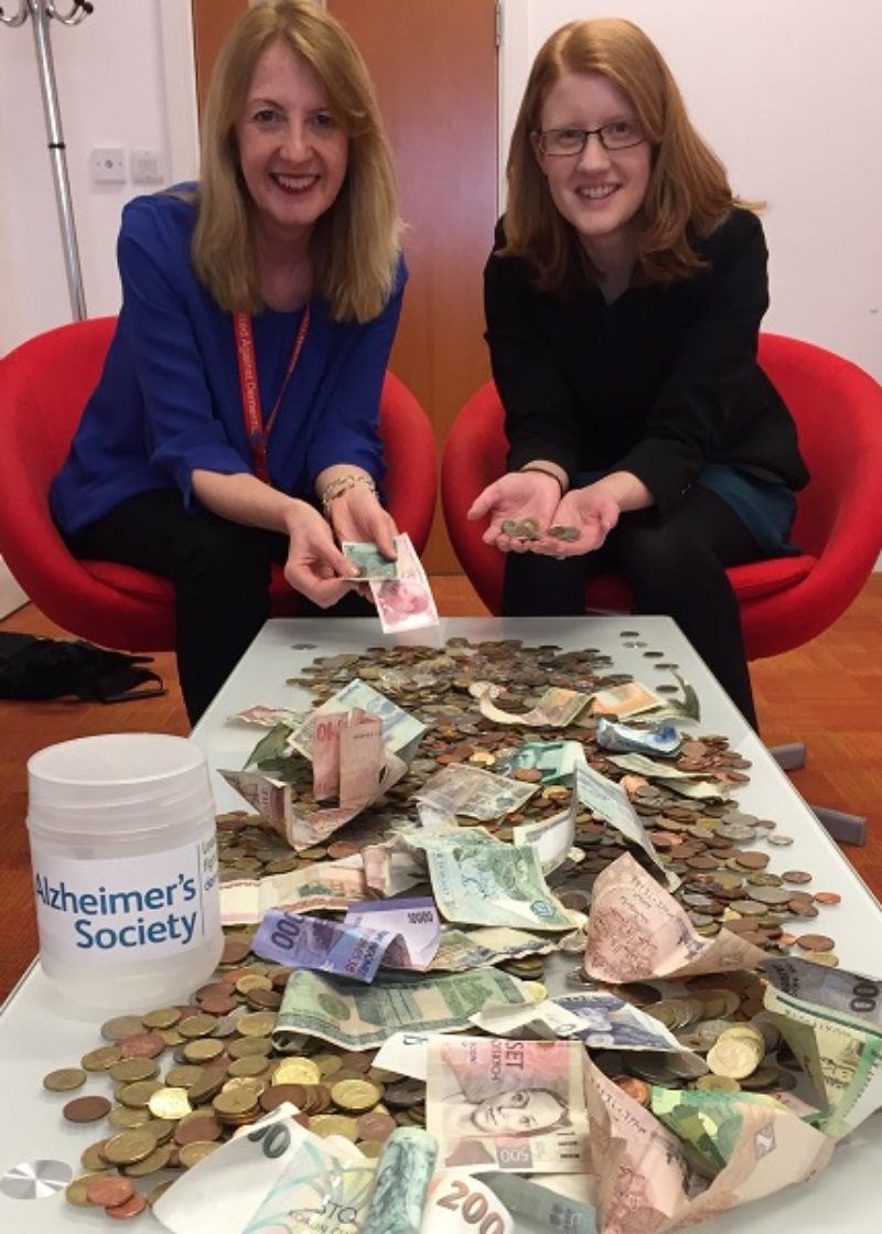 Holly Lynch with coins collected for dementia campaign